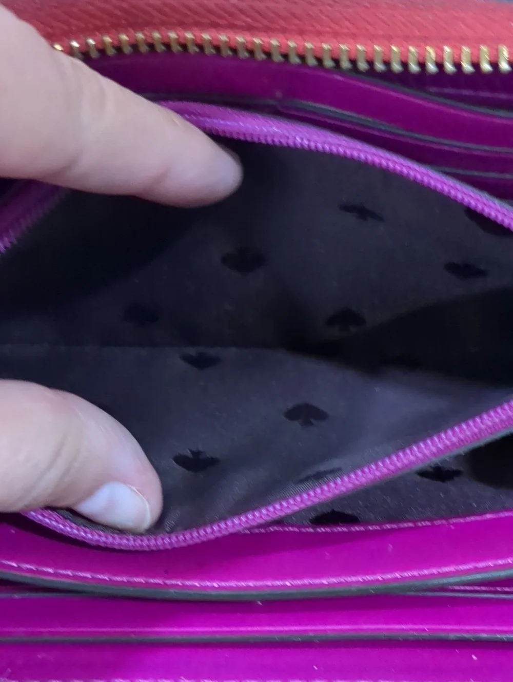 Kate Spade red zip-around wallet with Ace of Spades patch